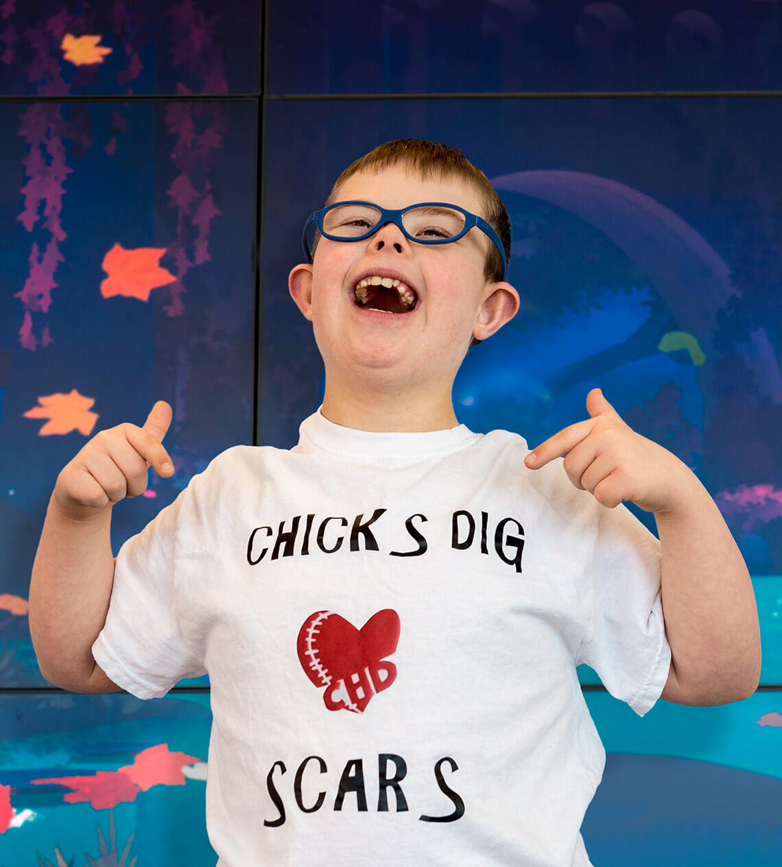 Pediatric cardiology patient Jacob Worley dances in front of a wall.