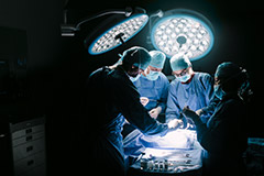 Doctors and nurses working on a patient during a surgery.