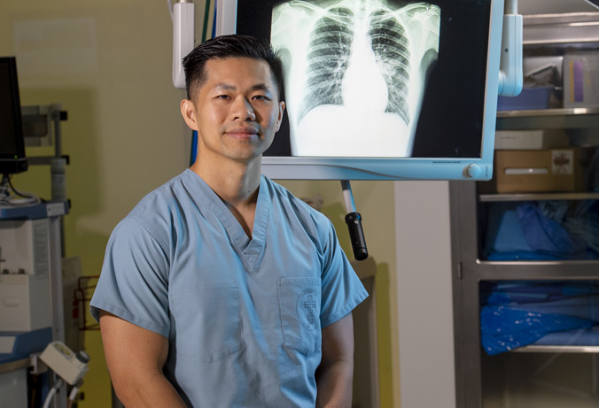Jay Pham standing inside of an operating room.